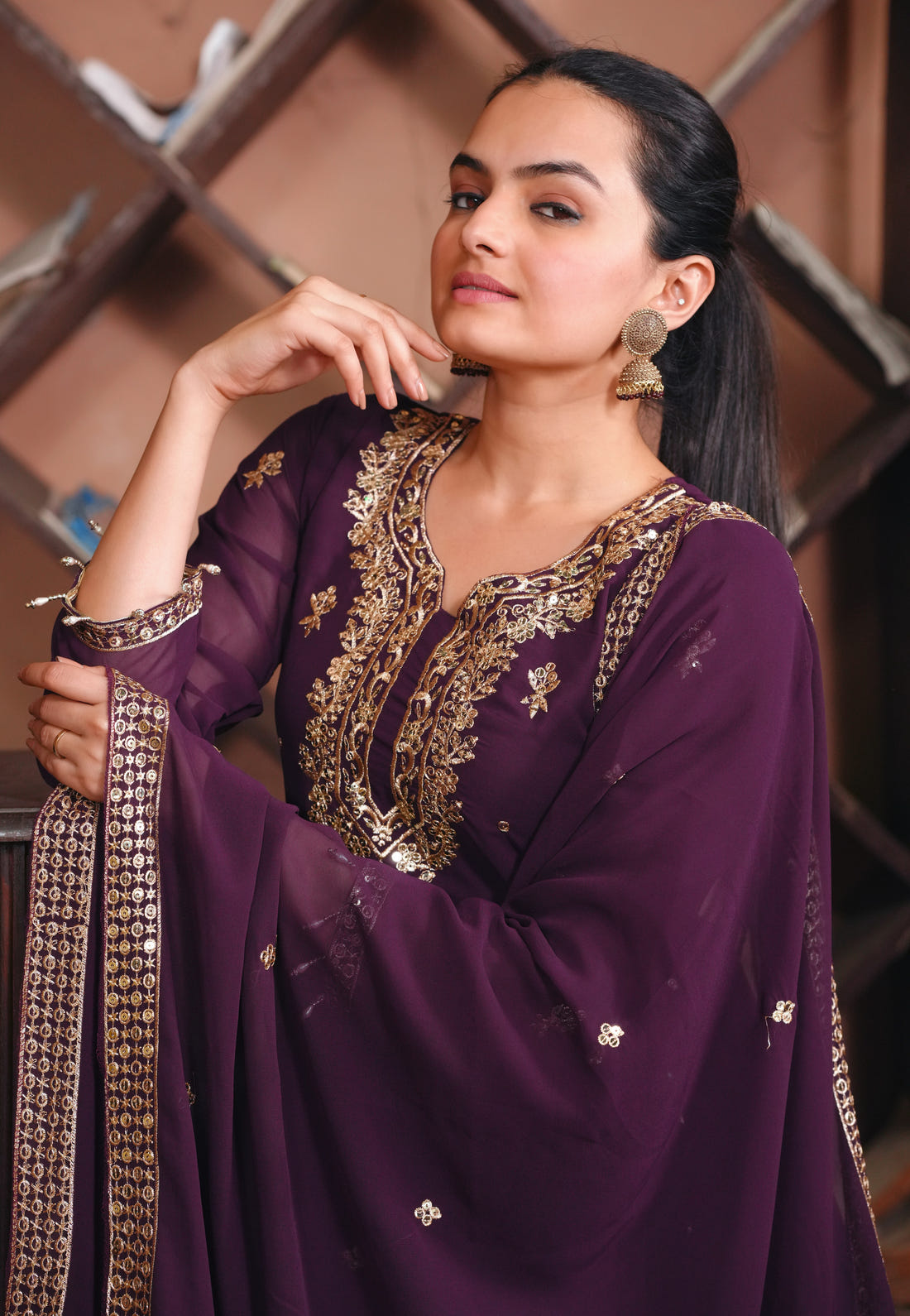 Purple Georgette Anarkali Suit with Intricate Golden Zari & Sequin Detailing          Ask ChatGPT