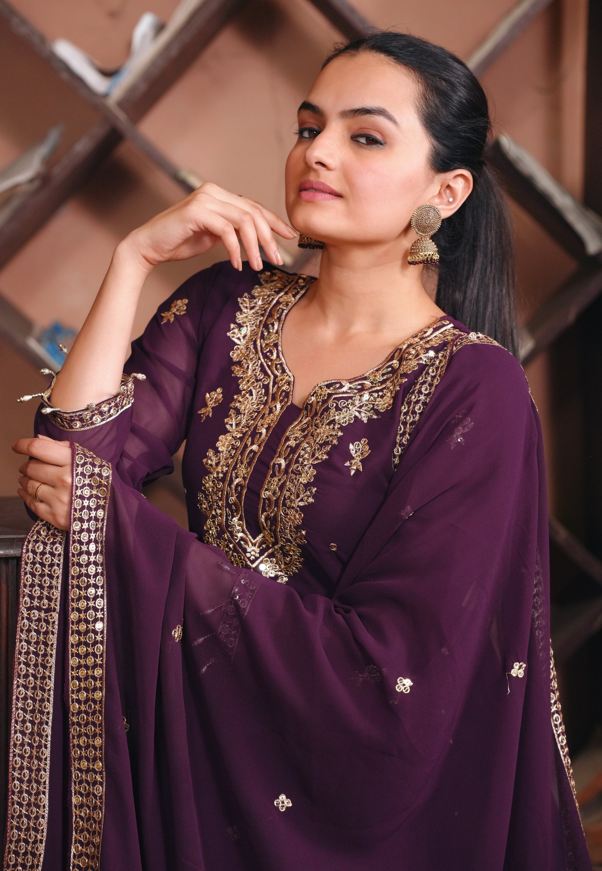 Purple Georgette Anarkali Suit with Intricate Golden Zari & Sequin Detailing          Ask ChatGPT