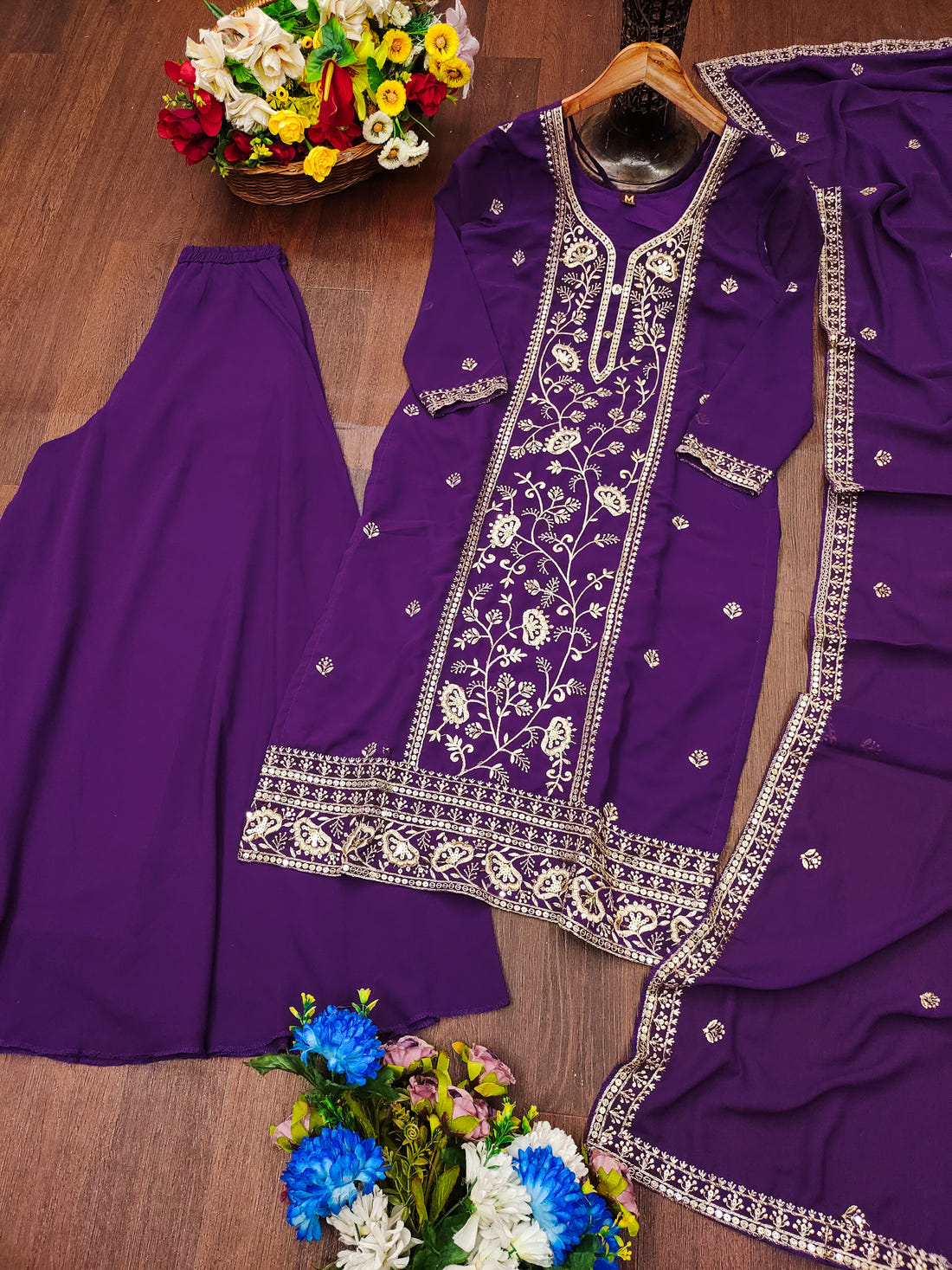 Purple Georgette Anarkali Suit with Intricate Golden Zari & Sequin Detailing          Ask ChatGPT