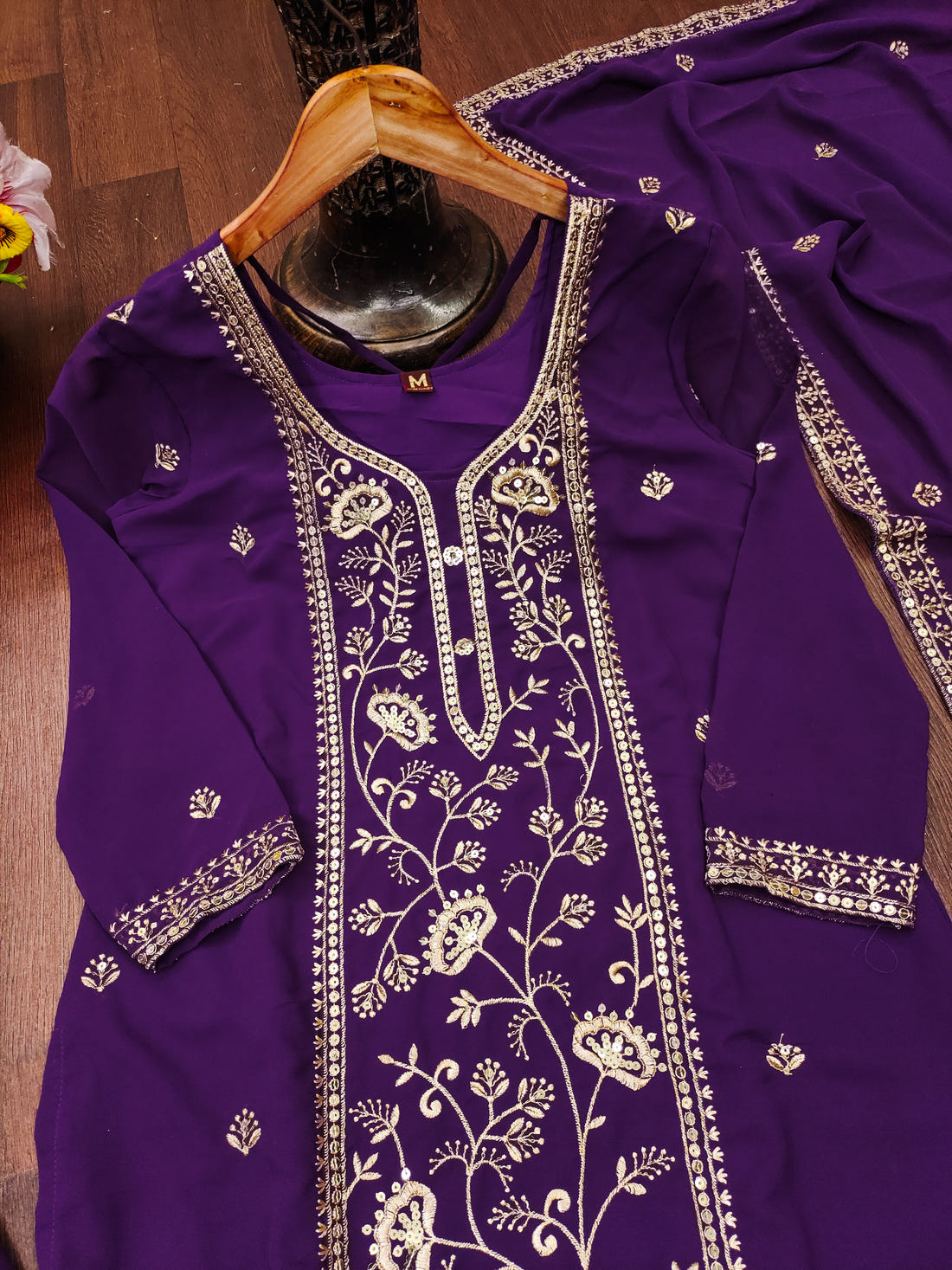 Purple Georgette Anarkali Suit with Intricate Golden Zari & Sequin Detailing          Ask ChatGPT