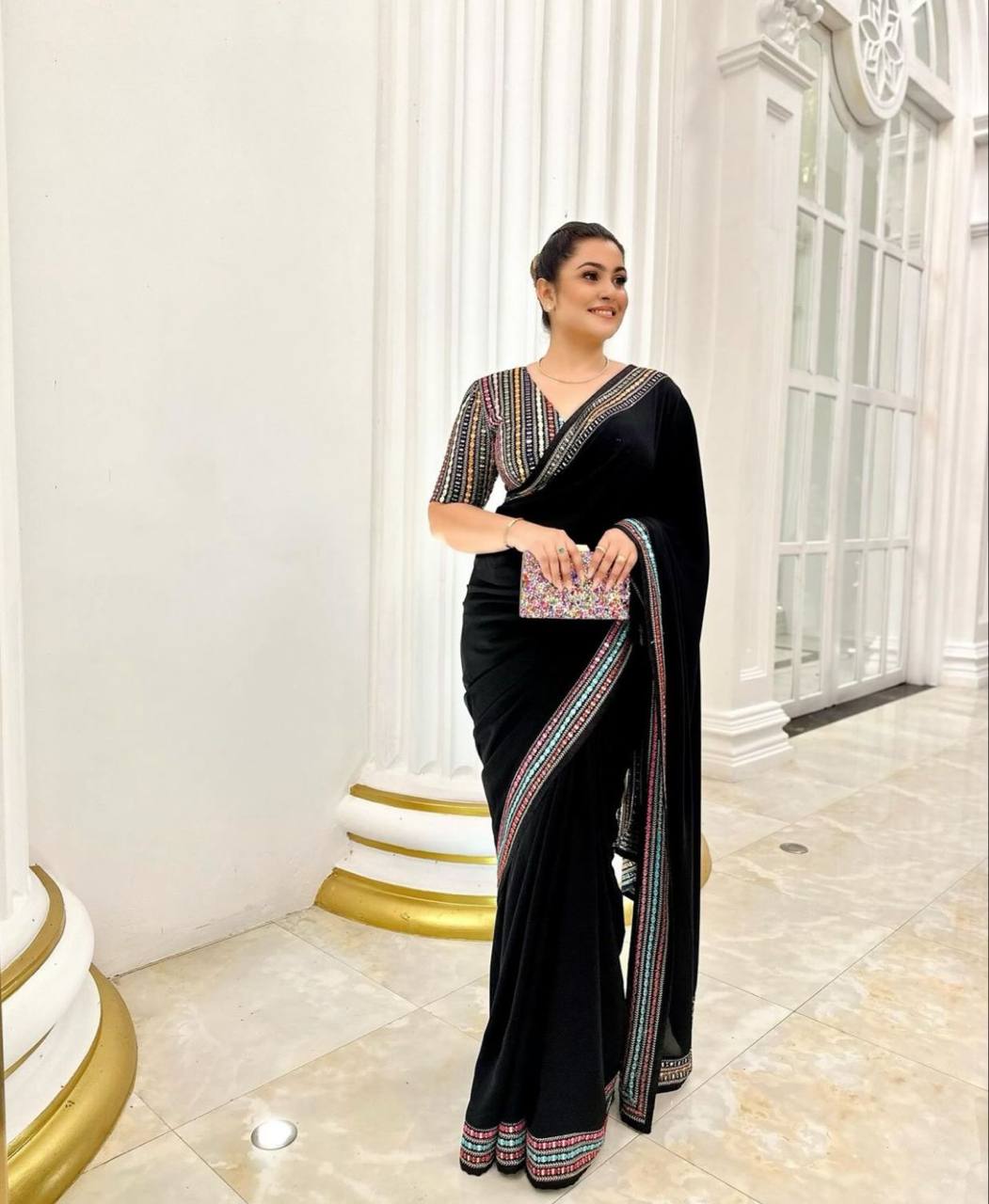 Black Elegant Georgette Saree with A Multicolour Embroidered Blouse