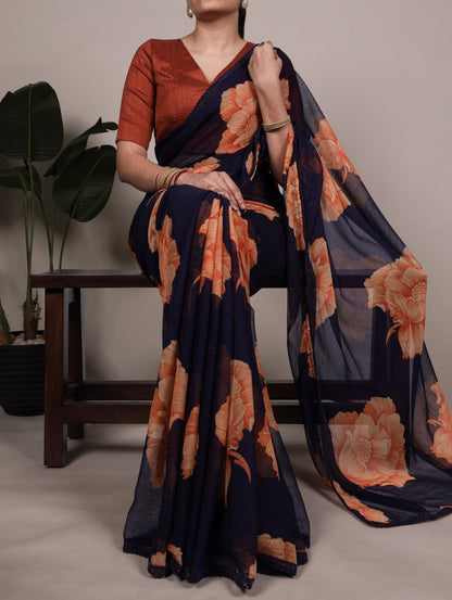 Navy Blue Chiffon Saree With A Orange Floral Print And Lace Border