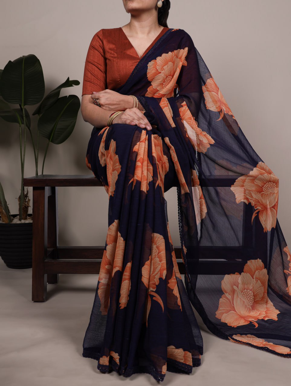 Navy Blue Chiffon Saree With A Orange Floral Print And Lace Border