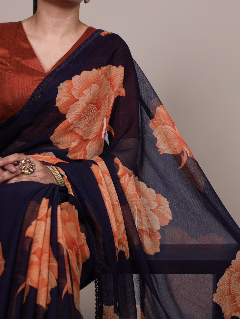 Navy Blue Chiffon Saree With A Orange Floral Print And Lace Border